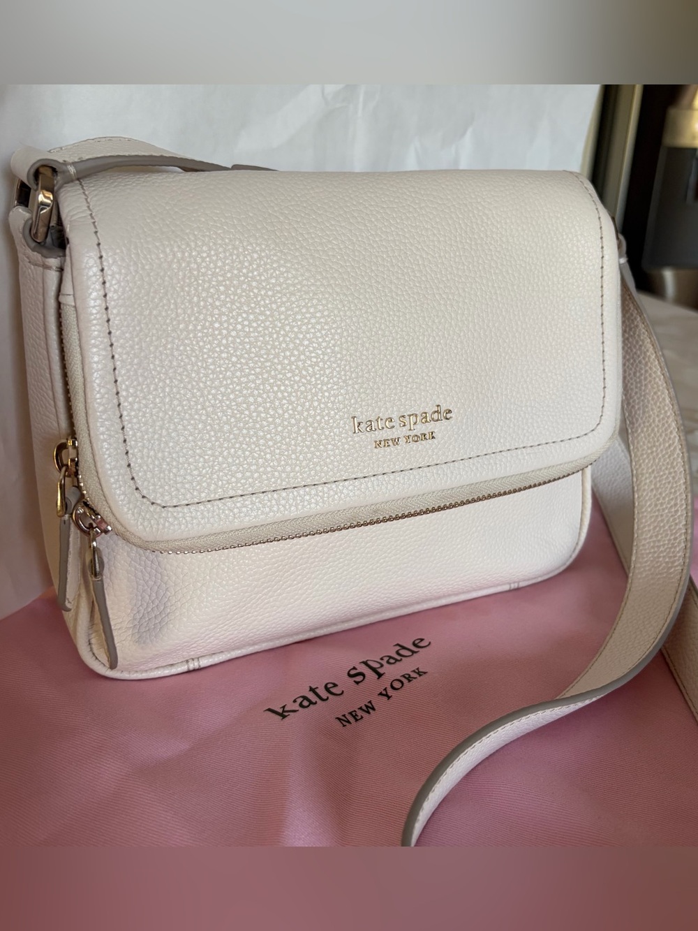 kate spade cream/white pebbled leather crossbody with silver logo and hardware